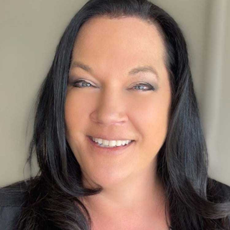 Portrait of Donna, a professional stylist at Visions Salon, showcasing their expertise and style.