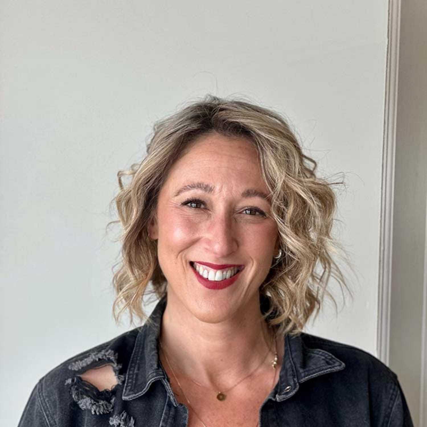 Portrait of Sarah, a professional stylist at Visions Salon, showcasing their expertise and style.