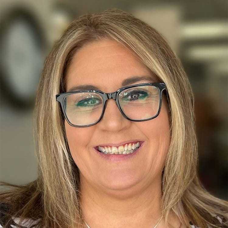 Portrait of Jenn D, a professional stylist at Visions Salon, showcasing their expertise and style.