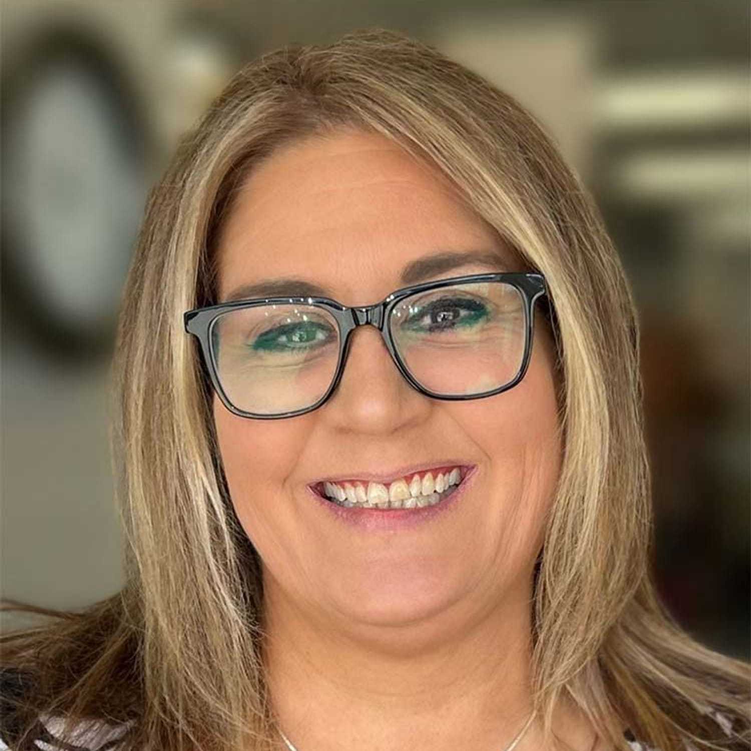 Portrait of Jenn D, a professional stylist at Visions Salon, showcasing their expertise and style.