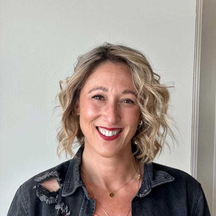 Portrait of Sarah, a professional stylist at Visions Salon, showcasing their expertise and style.